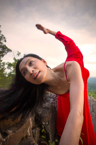 istock Dancer in red dress doing a lunge outdoors in Connecticut. 1178612580