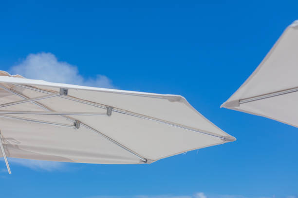 istock Beautiful white umbrella behind blue sky. Exotic Paradise, Vacations Concept 1178612840