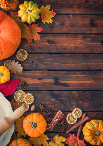 Autumn background with pumpkins, spices and candied oranges