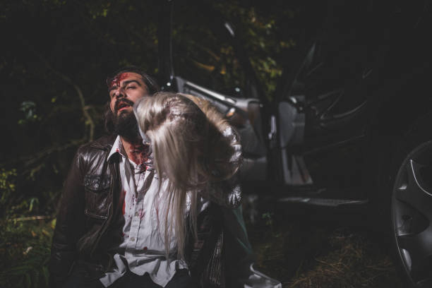 Undead zombie woman biting man Woman dressed as witch biting man at night. Zombie concept male vampire biting his victim stock pictures, royalty-free photos & images