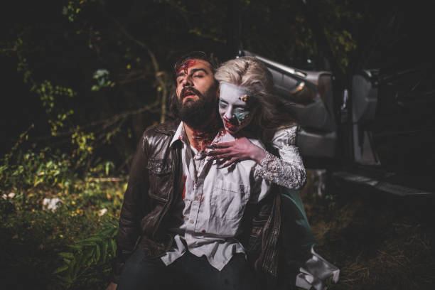 Zombie biting man Woman dressed as witch biting man at night. Zombie concept male vampire biting his victim stock pictures, royalty-free photos & images
