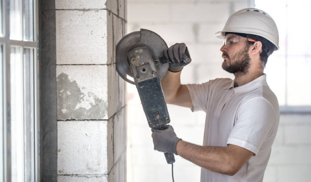 istock The industrial Builder works with a professional angle grinder to cut bricks and build interior walls. Electrician. 1178616493