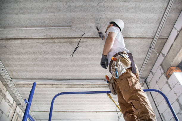 istock Electrician installer with a tool in his hands, working with cable on the construction site. 1178616496