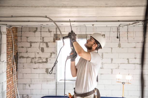 istock Handyman uses jackhammer, for installation, professional worker on the construction site. The concept of electrician and handyman. 1178616501