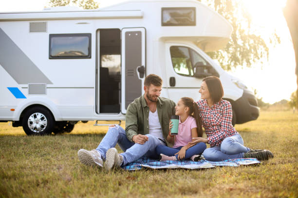 Camping in a RV Family camping in a recreational vehicle. About 30 years old parents and a 8 years old daughter, all Caucasian people. mobile home stock pictures, royalty-free photos & images