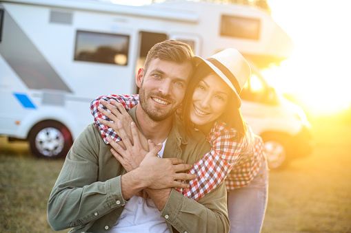 Couple camping in a recreational vehicle. About 30 years old Caucasian people.