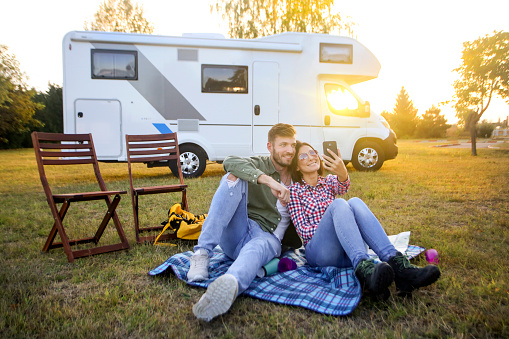 Couple camping in a recreational vehicle. About 30 years old Caucasian people.