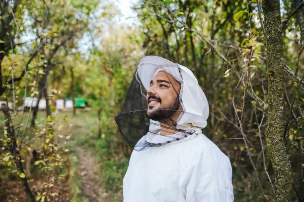 Young beekeeper with protective clothing