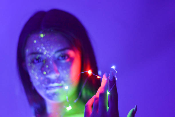 istock Young woman portrait with flourescente make up and uv light 1178619464