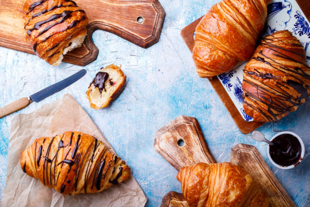 istock Breakfast Continental  with many Fresh  Croissants with Chocolate and sauce on a blue Background  Delicious Baking Top View Copy space for Text 1178619599