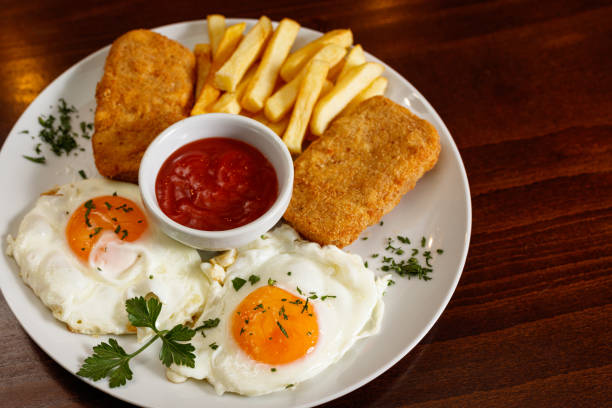 Sunny side up eggs with cheese and french fries