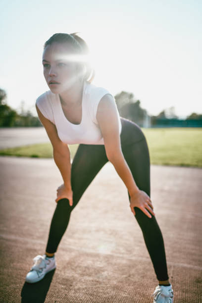 istock Female Athlete Stretching On Running Track 1178621233