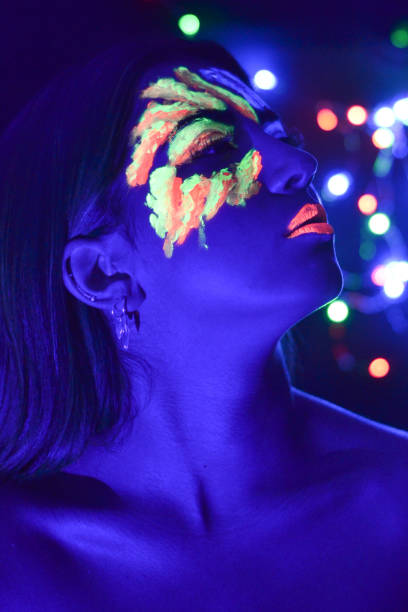 istock Young woman portrait with fluorescence make up and uv light 1178621344