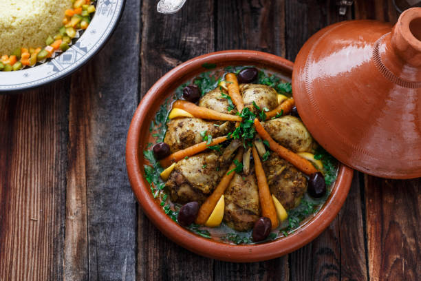 istock Slow cooked chicken with carrots, morrocan tajine, copy space. 1178622232