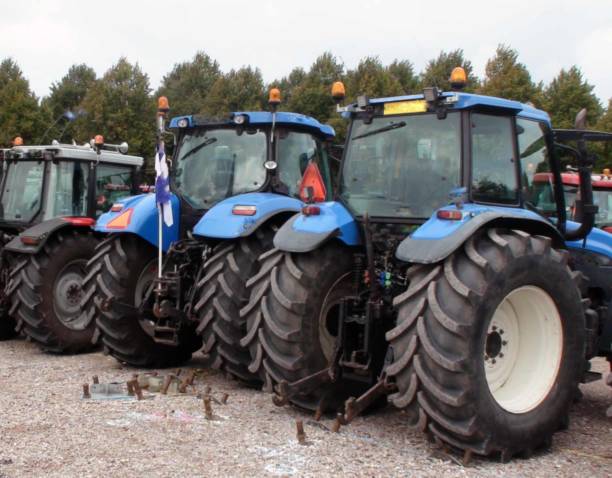 istock Tractor Agricultural Machinery Plus Tree Scenery 1178622564