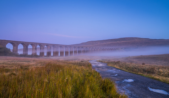 Misty and foggy sunrise over Ribble head viaduct in north Yorkshire