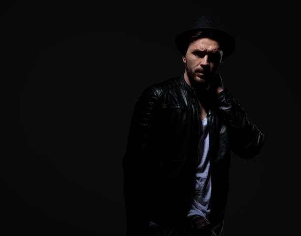 istock fashion model wearing leather jacket and hat 1178624404