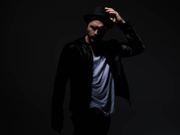 istock fashion model wearing leather jacket and hat 1178624913