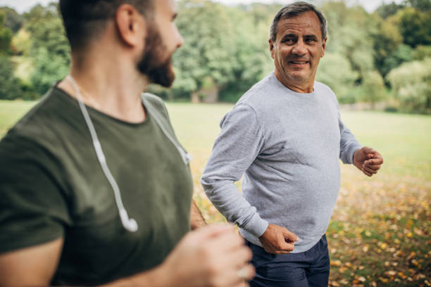 istock Father and son jogging in park 1178625061