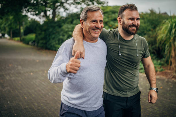 istock Father and son jogging in park 1178625136