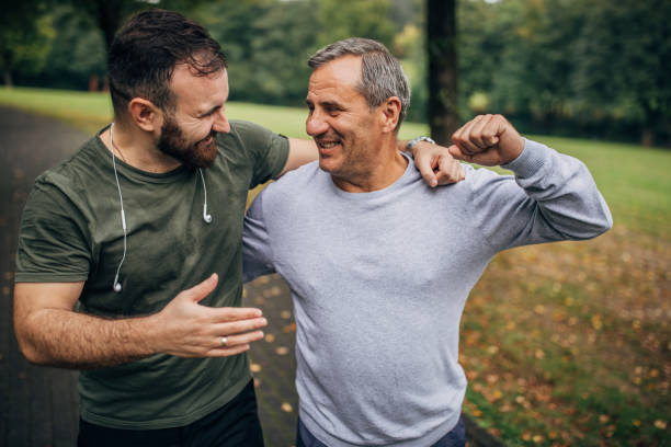 istock Father and son jogging in park 1178625178