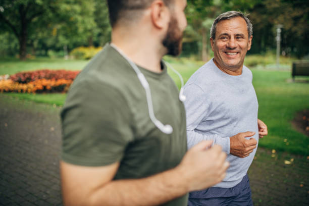 istock Father and son jogging in park 1178625213