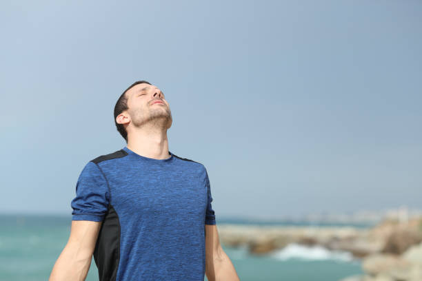 istock Serious runner breathing fresh air on the beach 1178627851