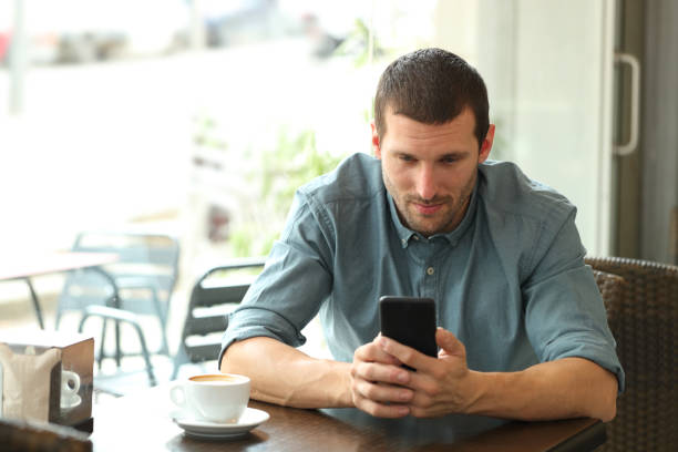 istock Adult man using a smart phone in a coffee shop 1178627874