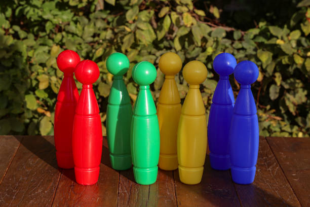 istock Colorful plastic toy bowling pins on wooden floor 1178631473