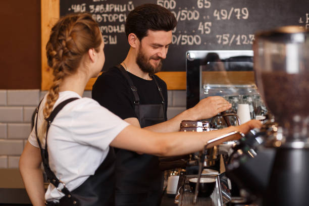 istock Professional barista team brewing coffee using coffee machine in coffee shop. 1178644089