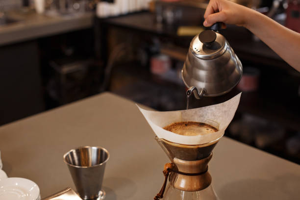 istock Professional barista preparing coffee using glass coffeemaker pour over coffee maker and drip kettle. 1178644108