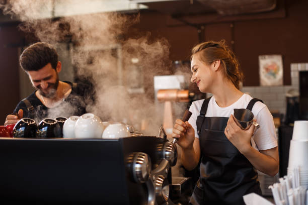 istock Professional barista team brewing coffee using coffee machine in coffee shop. 1178644243