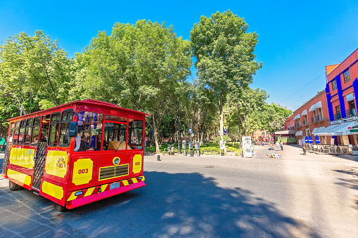 Coyoacan, Mexico City, Mexico-20 April, 2019: Tourist bus taking tourists on a tour around Coyoacan