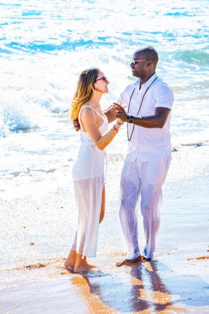istock Couple young multi ethnic dancing on the beach 1178645602