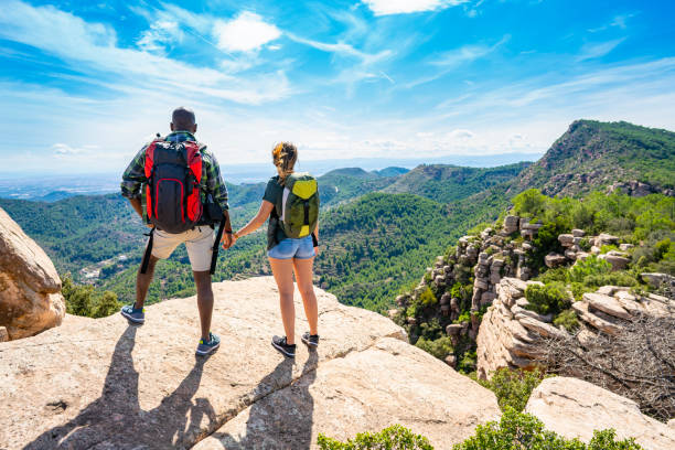 istock Couple young mixed ethnic trekking looking peak 1178646125