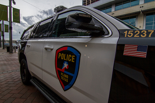 Plano police cruiser parked near shops for extra security in the town of  Plano Texas