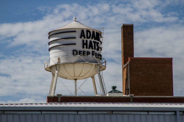 The water tower with Adams hats sits in Deep Ellum near downtown Dallas Texas.