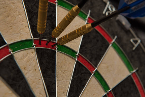 istock Three darts accurately hit the same area of a dart board 1178660909