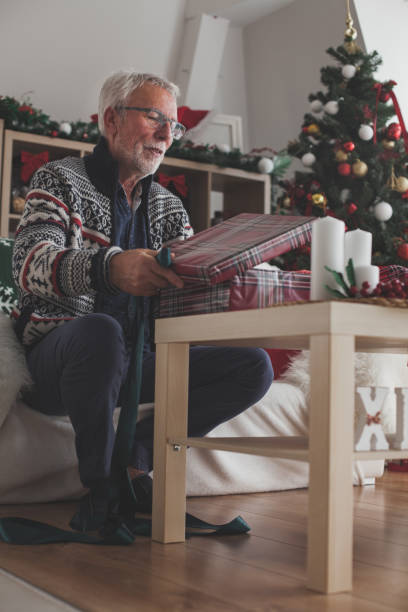 istock Senior man wrapping a Christmas gift 1178664887