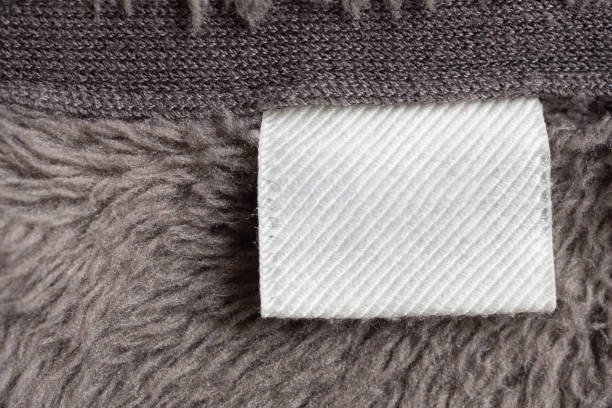 istock Blank white laundry care clothing label on fur texture background 1178664926