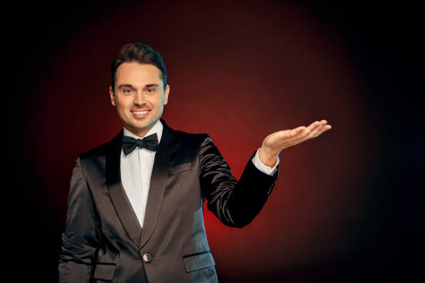 istock Professional Occupation. Showman in suit standing isolated on wall showing copy space looking camera friendly 1178664941