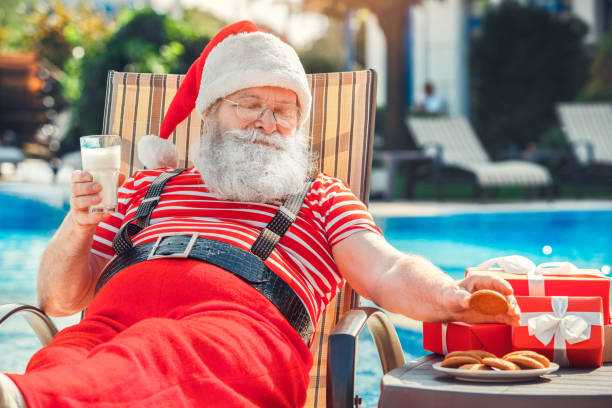 Santa Claus near the pool holiday vacation concept stock photo