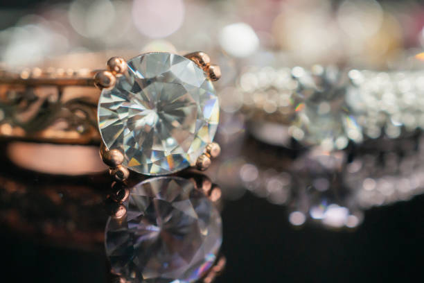 istock Jewelry wedding diamond rings on black background with reflection 1178665215