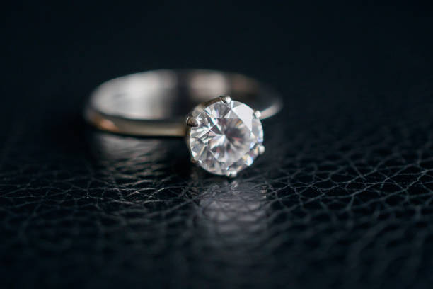 istock Close up diamond ring jewelry on black leather background 1178666078