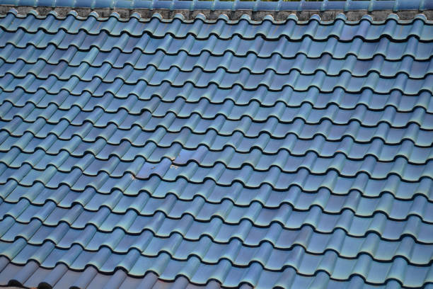 istock a construction site roofing black tiles on close up 1178666312