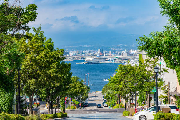 View of Hachiman-zaka Slope in summer sunny day white clouds and bule sky View of Hachiman-zaka Slope in summer sunny day white clouds and bule sky. A sloped street made famous in movies and commercials. Popular Sightseeing Spot in Hakodate City, Hokkaido, Japan motomachi kobe stock pictures, royalty-free photos & images