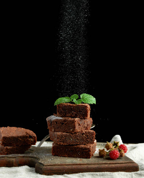 istock stack of square baked brownie chocolate cake slices sprinkled with white sugar 1178667555