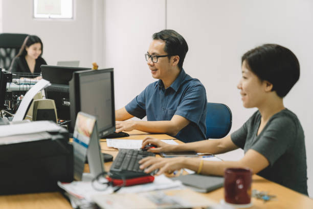 istock a small group of people working in the office using computers 1178669790