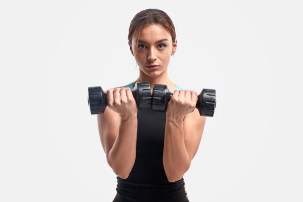 istock Athletic female exercising with dumbbells 1178672293