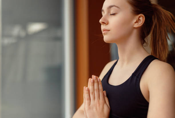 istock Young woman meditating with closed eyes 1178672371